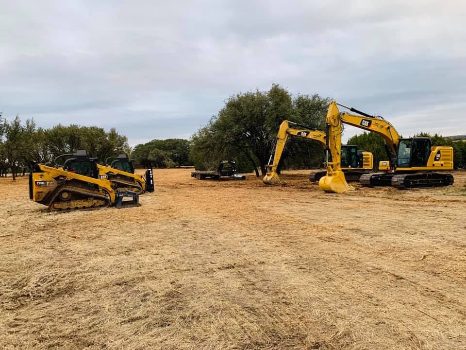 H&T Ranch Services CAT equipment fleet staged on a job site