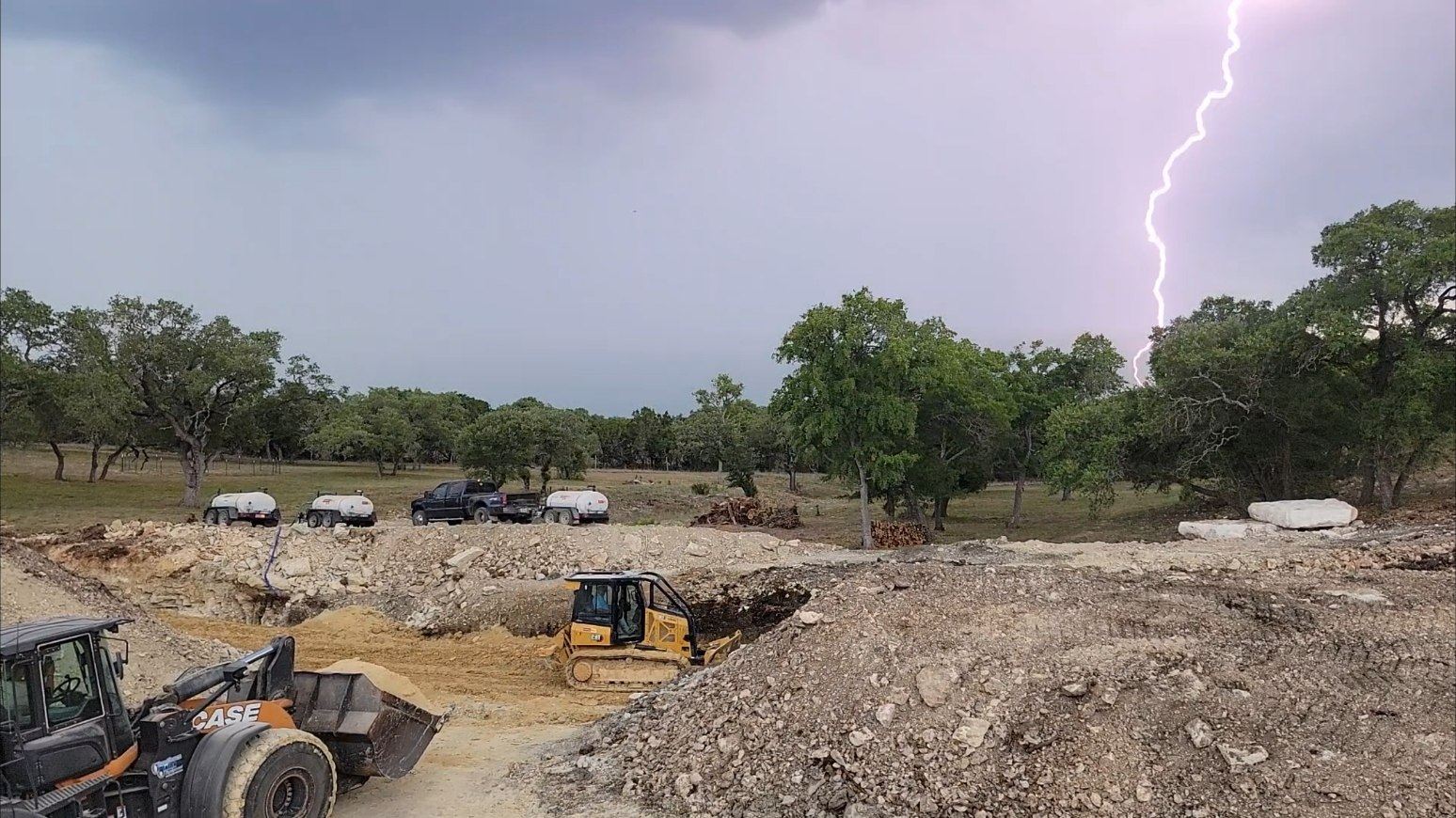 Lightning strike over a pond construction site