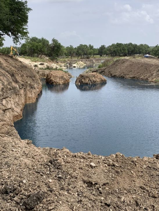 Newly constructed pond filling with water